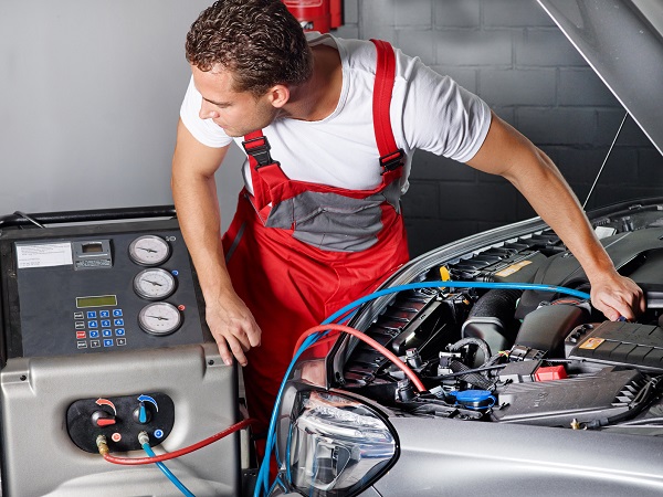 Car mechanic checks the air handling unit of a car